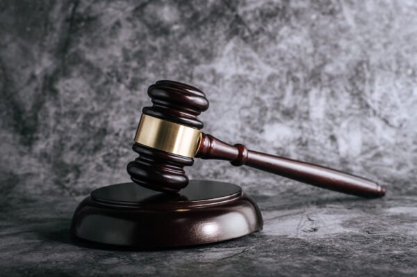 wooden judges gavel on table in a courtroom or enforcement office.